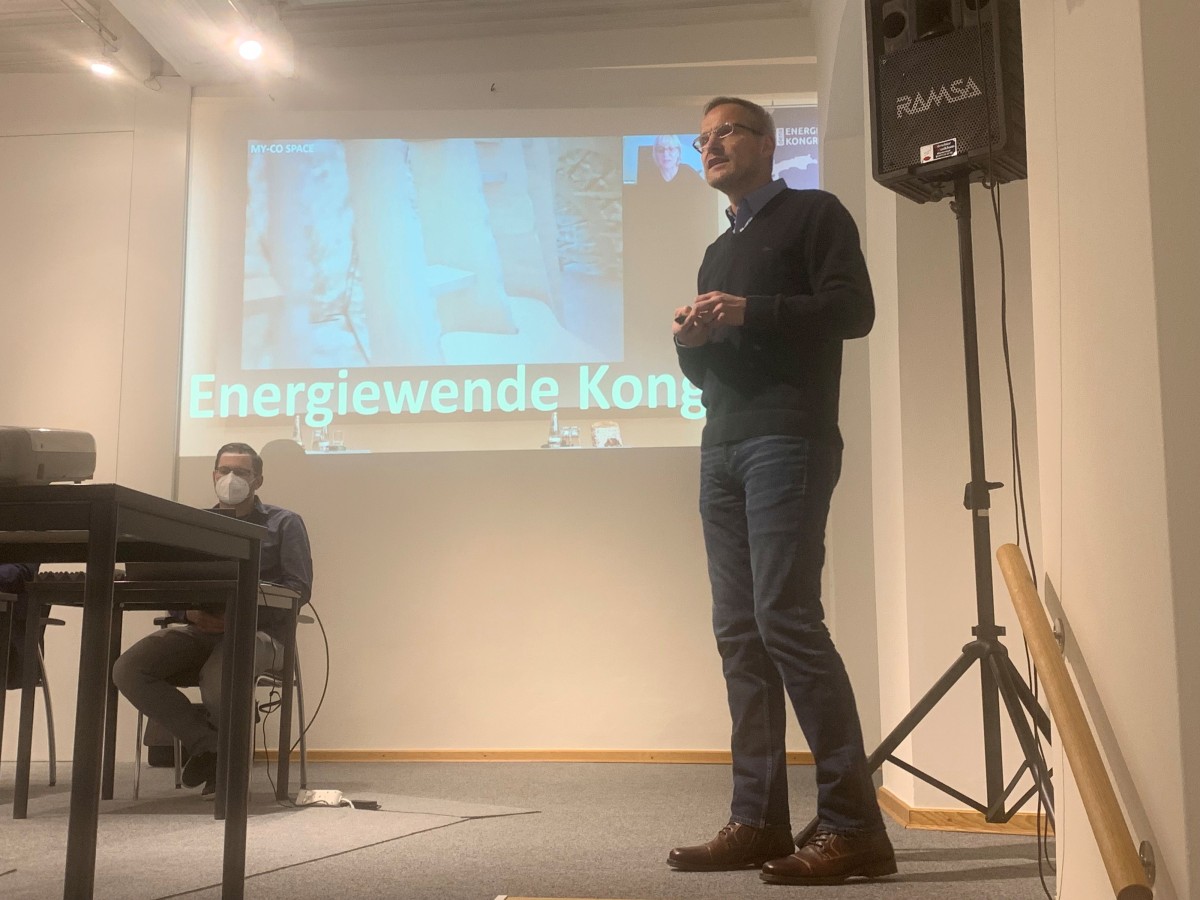 Vortragender auf einer Bühne, Vortragsfolie "Energiewende Kongress"